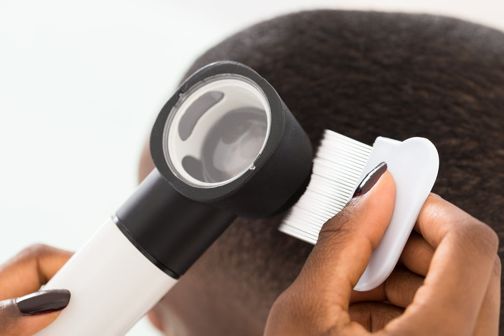Doctor checking a woman's scalp