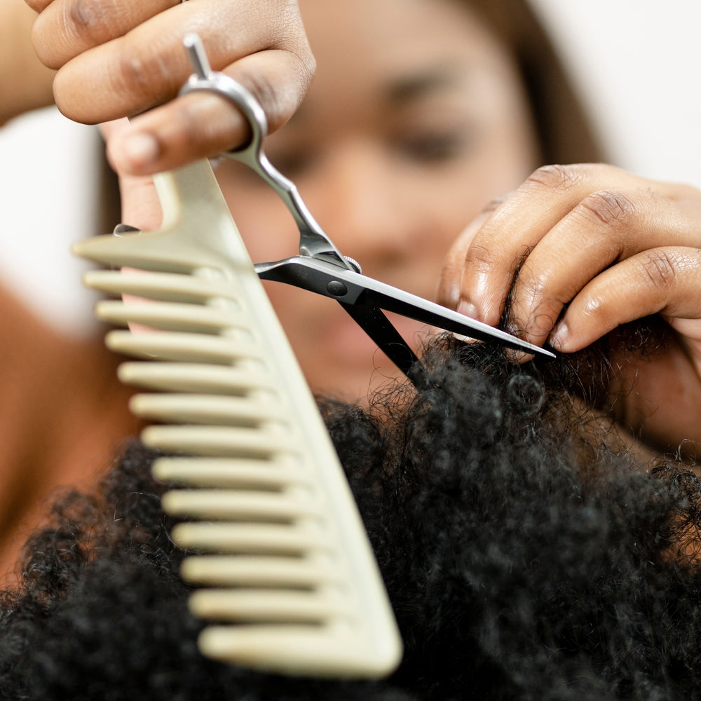 Stylist trimming hair