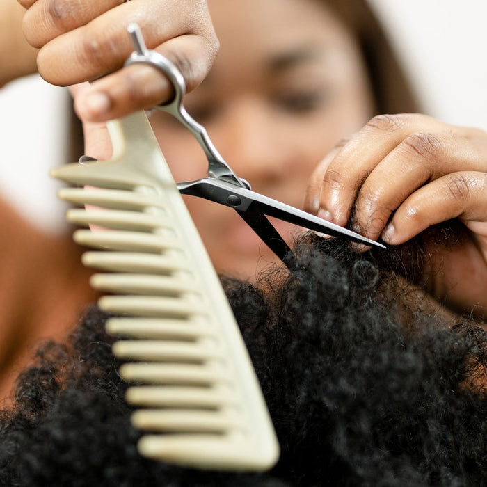 Stylist trimming hair