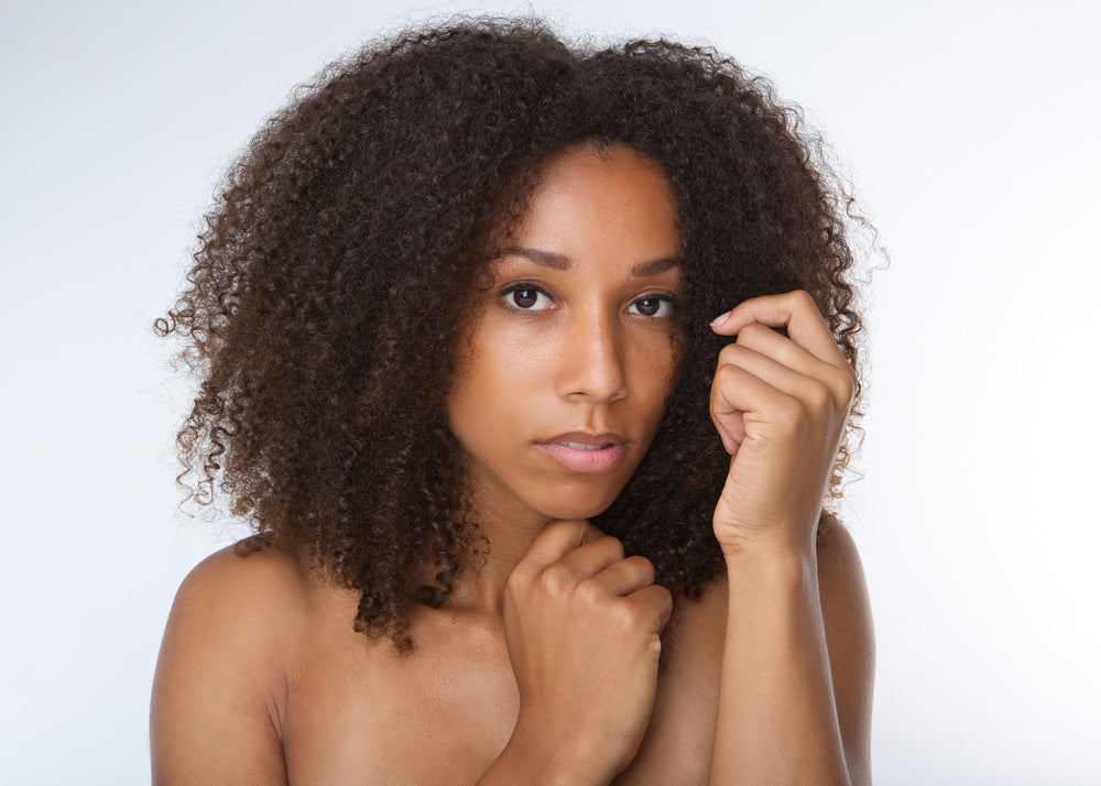 Doctor checking a woman's scalp
