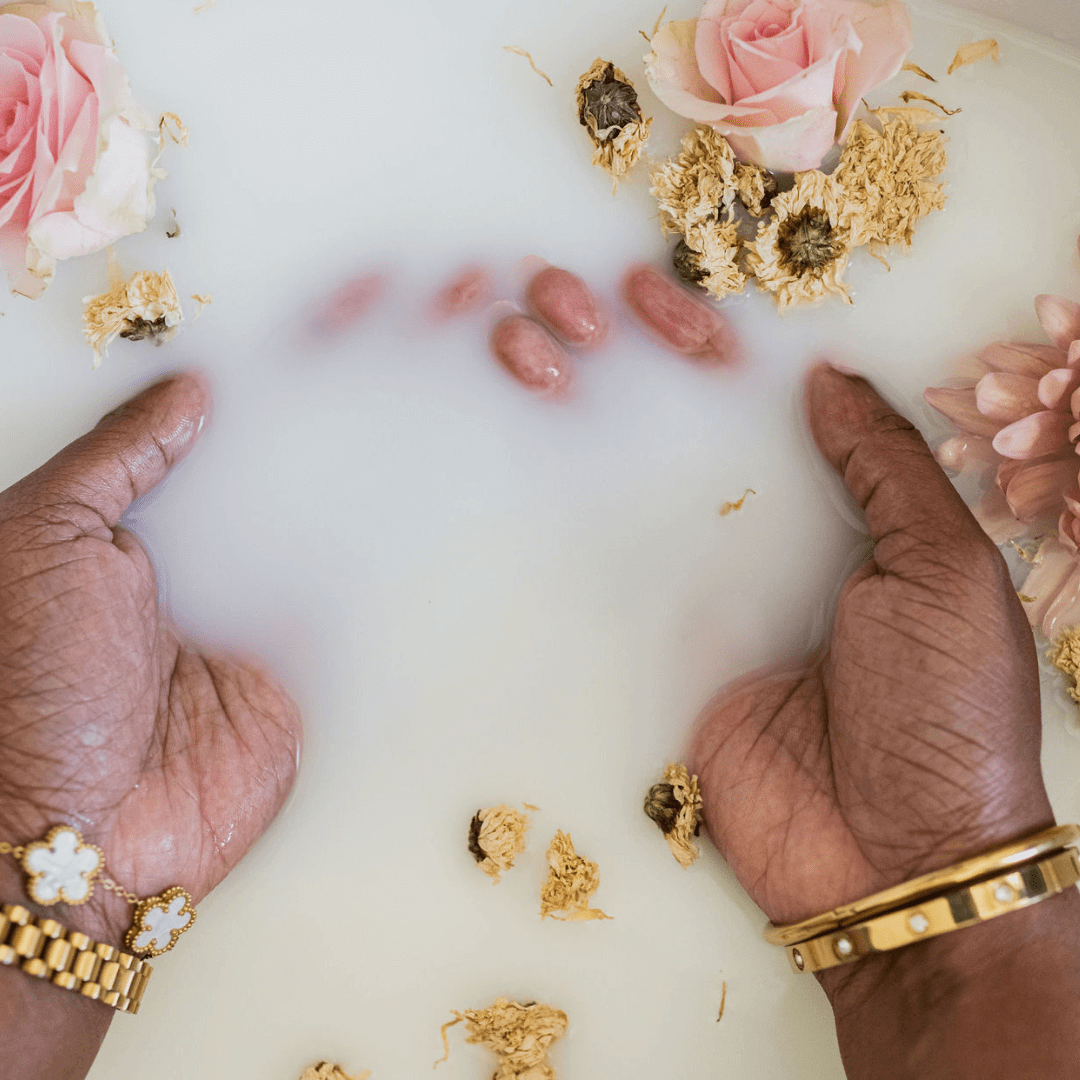 a person's hands resting in a sink of Replenish Me leave in conditioning milk