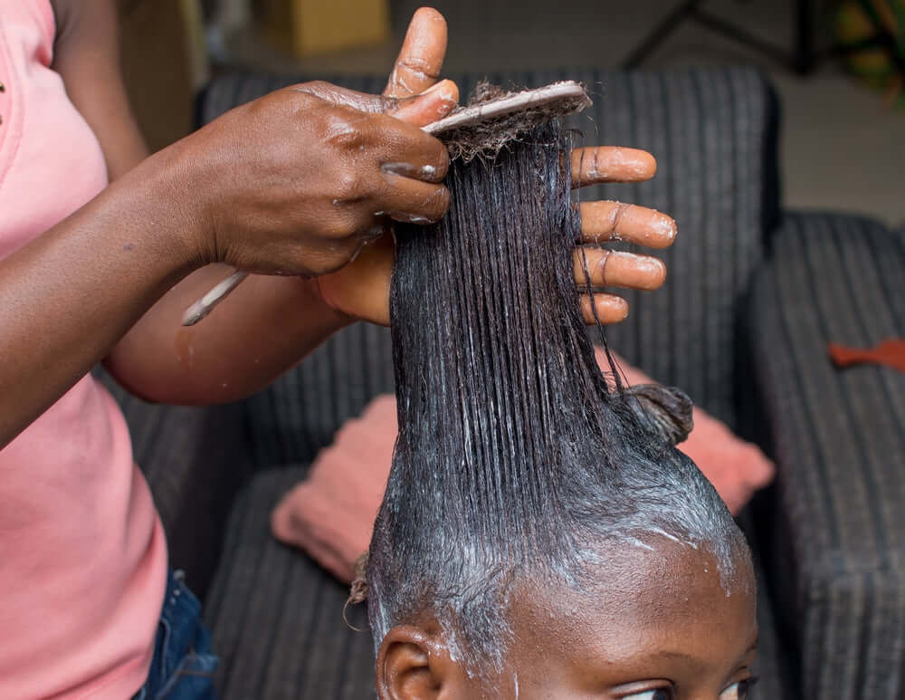 woman getting a hair relaxer