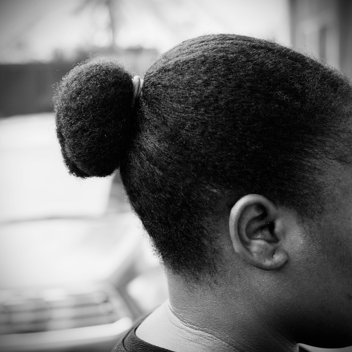 woman with 4c hair in a bun