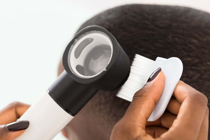 Doctor checking a woman's scalp