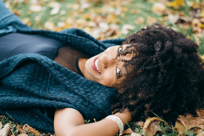 A woman laying on leaves