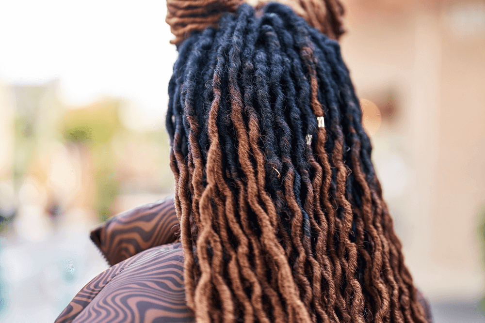 Back view of woman with color locs