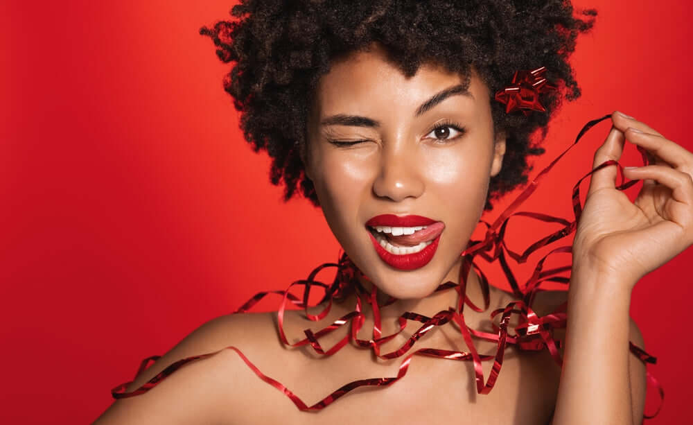Woman holding red holiday tinsel