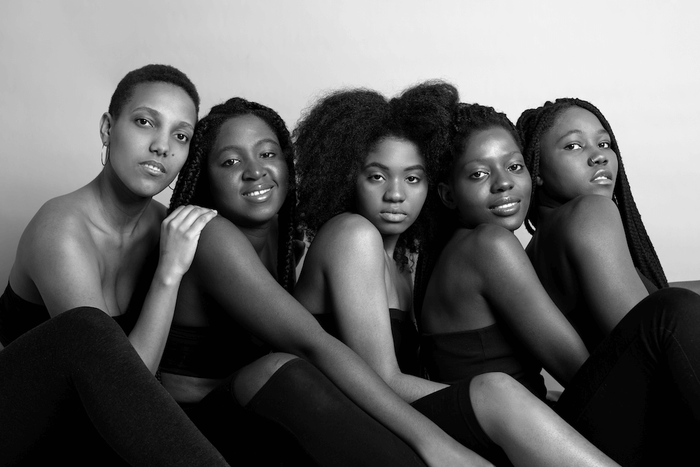 a group of women posing together and smiling
