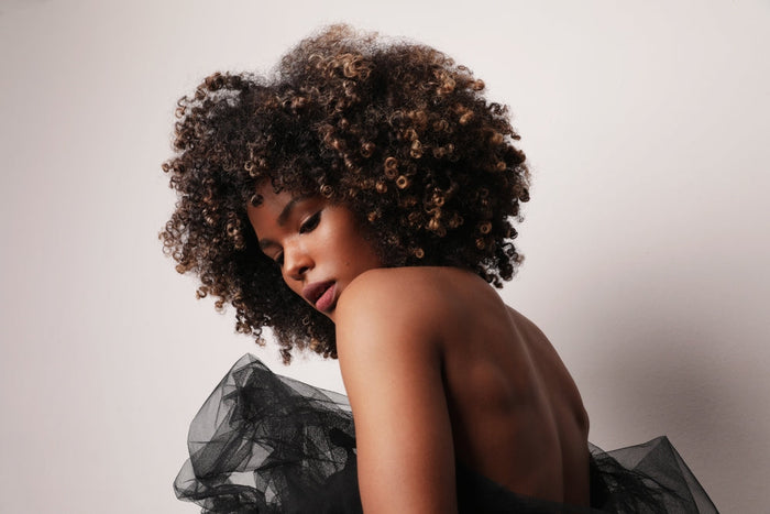 Profile of woman with curly fro