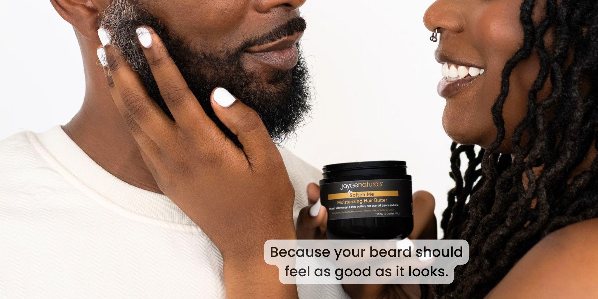 Two people with a jar of hair butter, with text 'Because your beard should feel as good as it looks.'