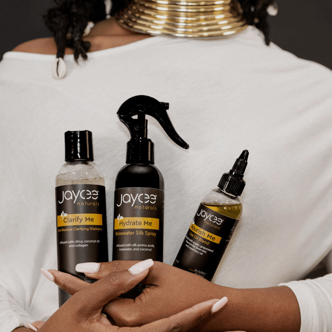 A woman with locs holding the loc maintenance bundle