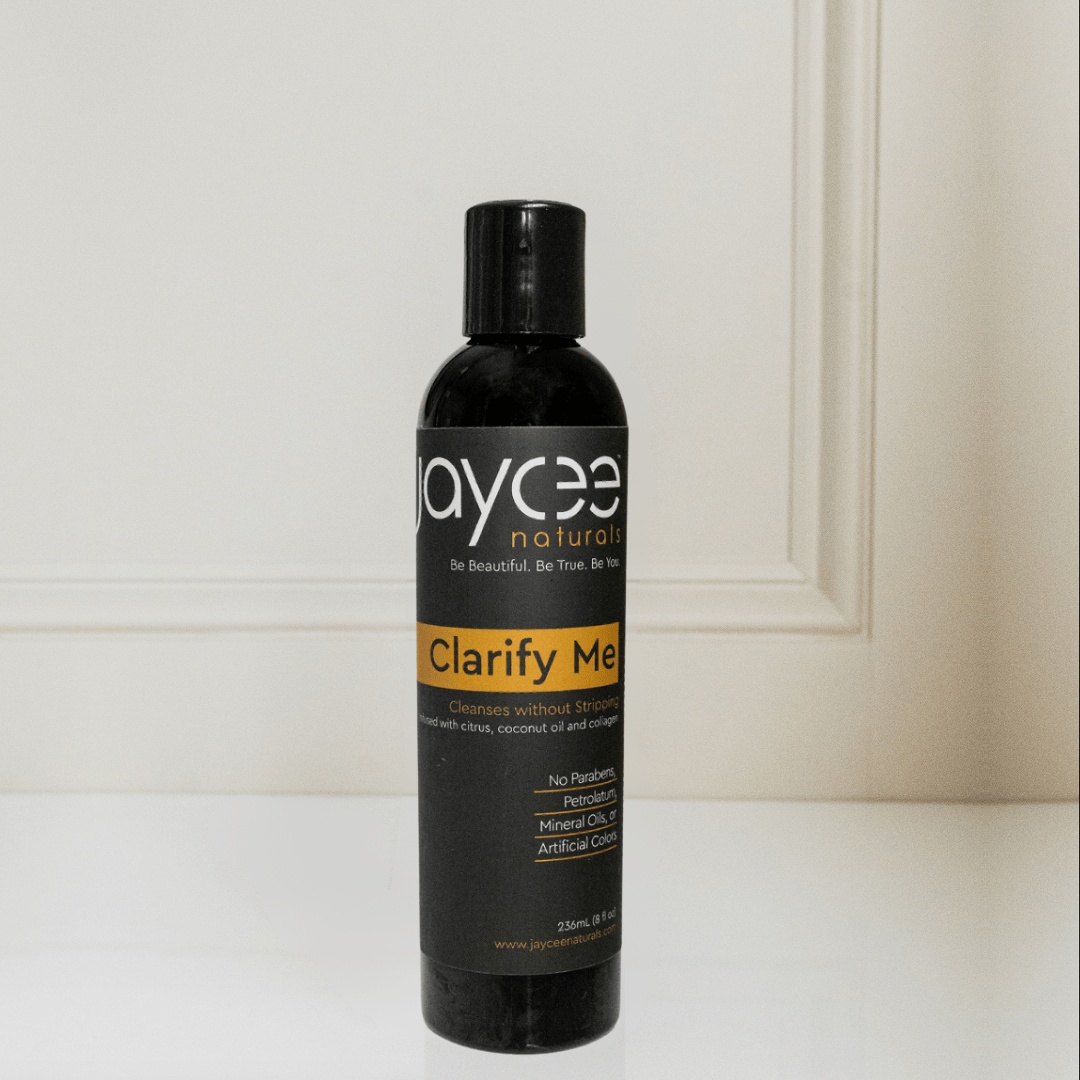 Jaycee Naturals Clarify Me Clarifying Shampoo, cleanses without stripping and free of sulfates, parabens, petrolatum, mineral oils, and artificial colors. 236ml bottle standing on a white countertop.