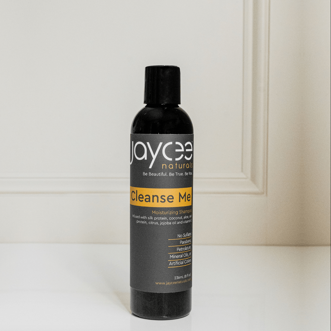 Jaycee Naturals Cleanse Me Moisturizing Shampoo, infused with silk amino acids and free of sulfates, parabens, petrolatum, mineral oils, and artificial colors. 236ml bottle standing on a white countertop.