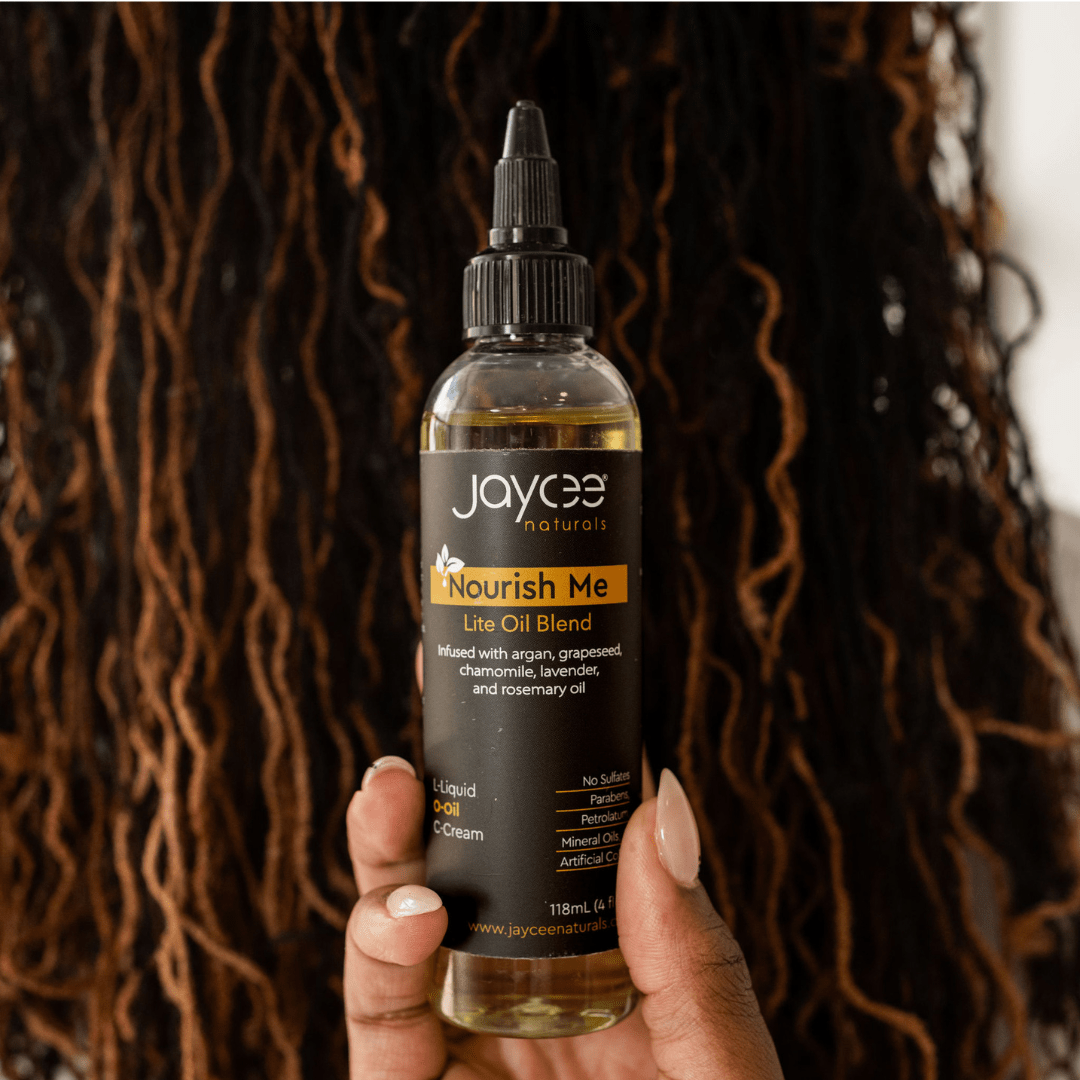 Bottle of Nourish Me posed in front of the back view of a woman with locs