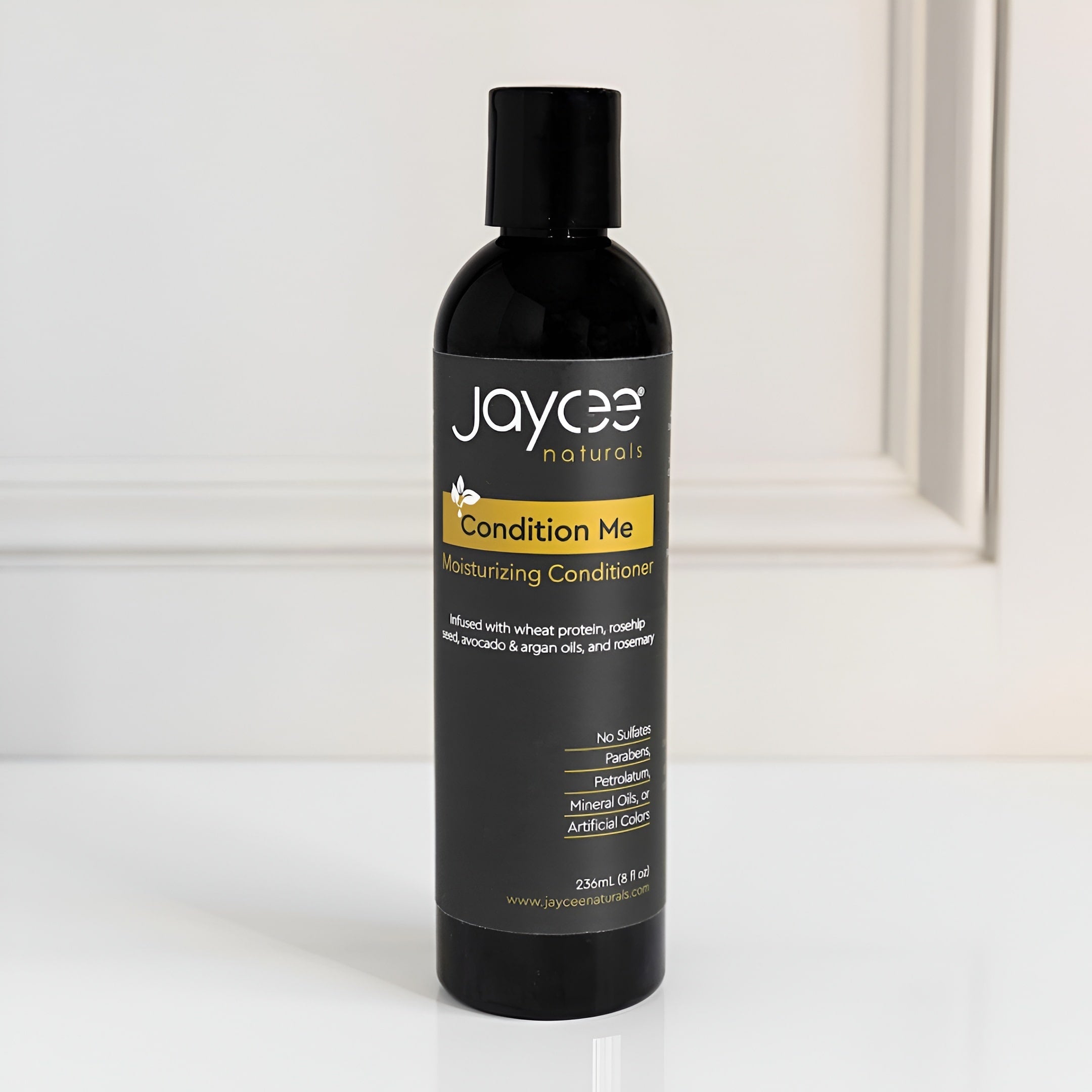 Black conditioner bottle with 'Jaycee Naturals' label on a white background