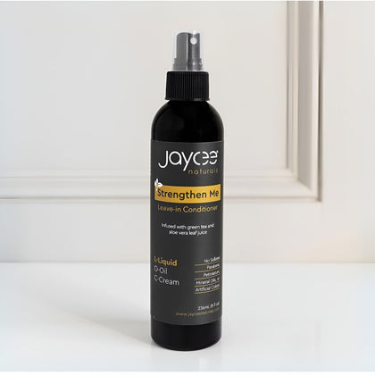 Jaycee Naturals Strengthen Me Leave-In Conditioner bottle on a white surface with a neutral background