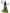 bottle of leave-in conditioner with tea leaves and aloe vera next to it and words to describe the leave-in conditioner